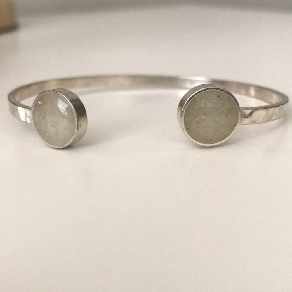 Hammered silver cuff bracelet with stone detail.